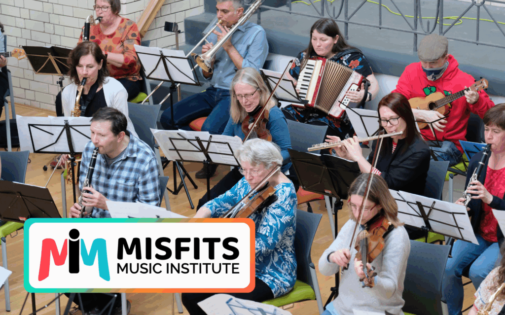 A community ensemble comprising of bass clarinet, trombone, accordion, ukulele, alto sax, violin, flute, clarinet and bass guitar.